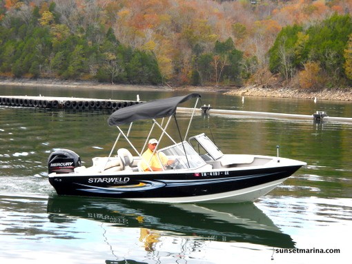 photo of man driving boat