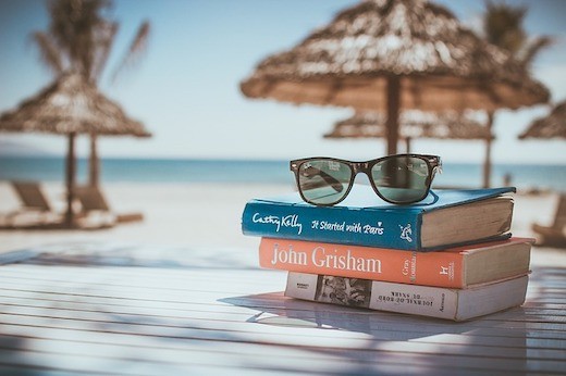 sunglasses on pile of books